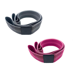 Two fabric resistance bands rolled up (One grey band and one pink band)